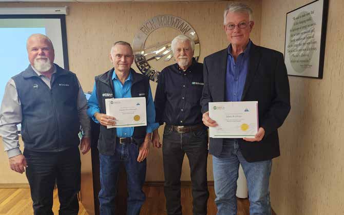 Photo of directors holindg their certificates of training. 